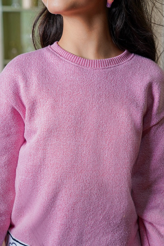 Close-up of a pink sweater worn by a person