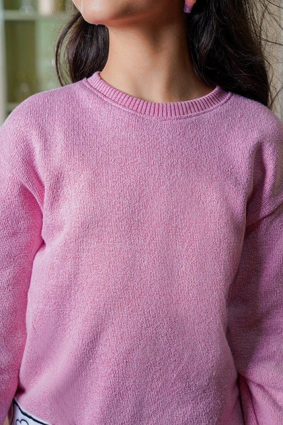 Close-up of a pink sweater worn by a person