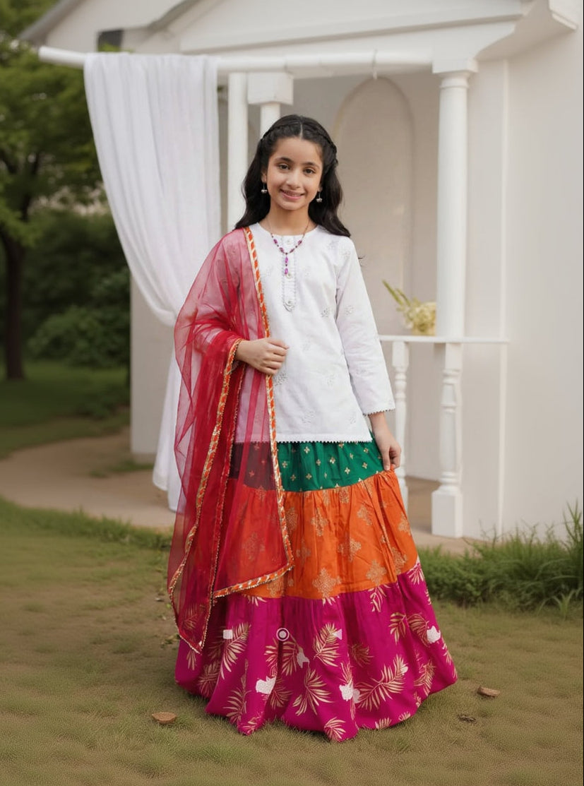 Woman in traditional outfit standing outdoors with a white building in the background
