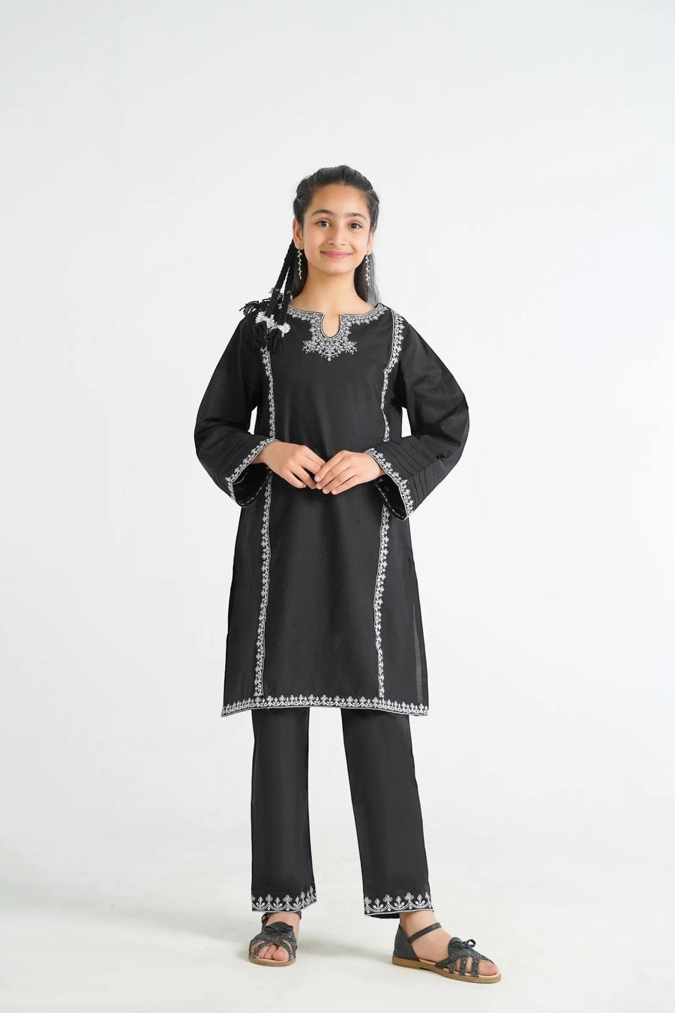 Lily black cotton kurta with white embroidery on neckline, sleeves, and hem, paired with matching pants.
