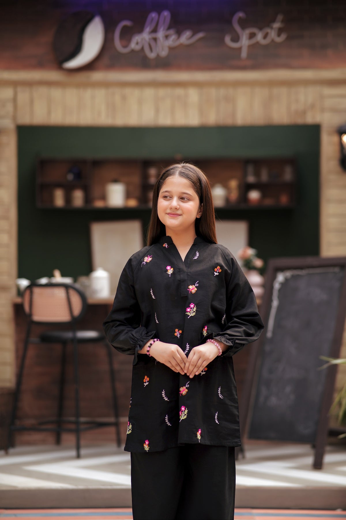 Lily girls black tunic and trouser set with multi-colored floral embroidery, V-neck, and ruffled long sleeves
