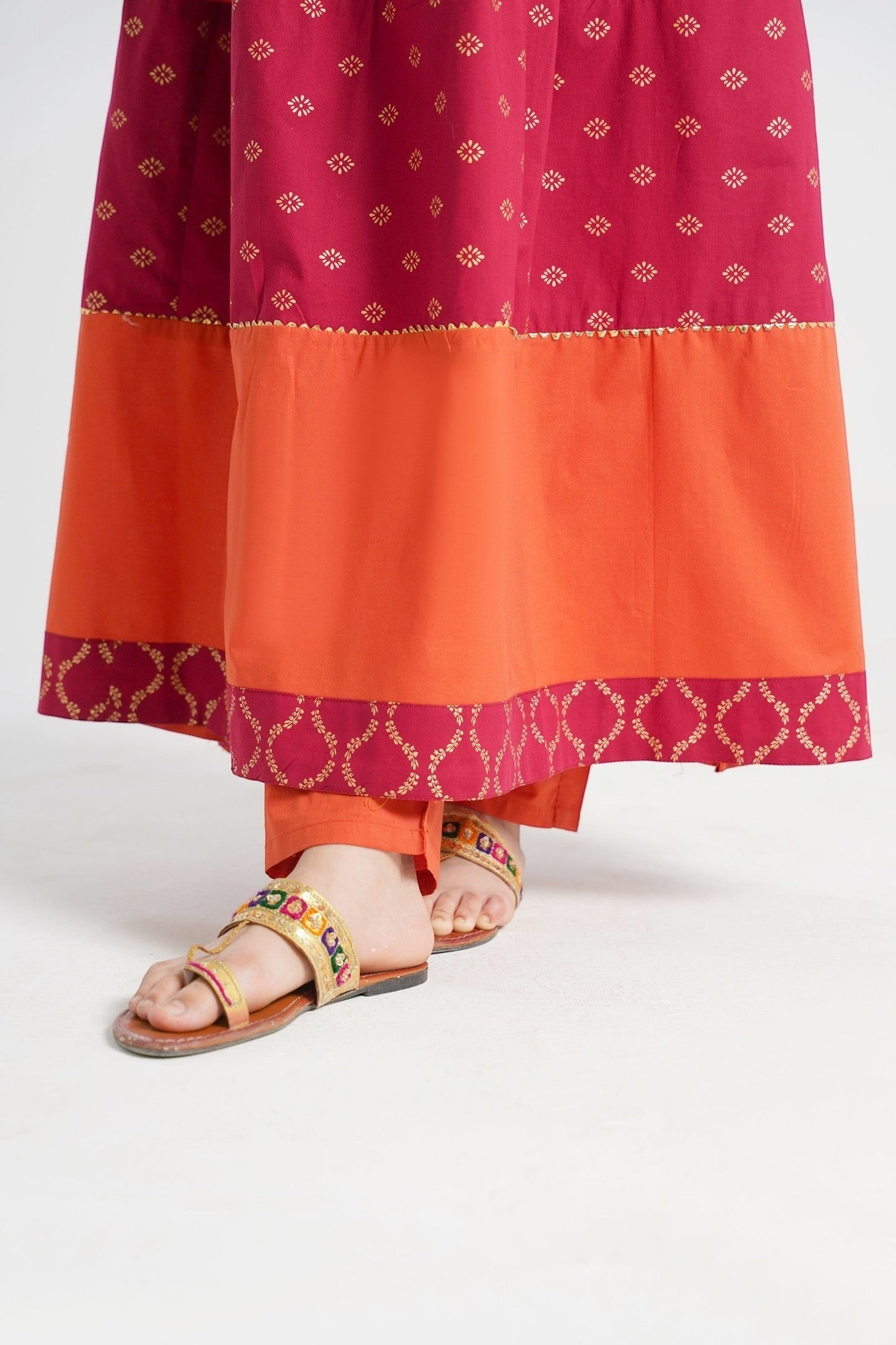 Lily orange embroidered kurta set for girls with maroon panels and gold print, paired with matching pants and dupatta.