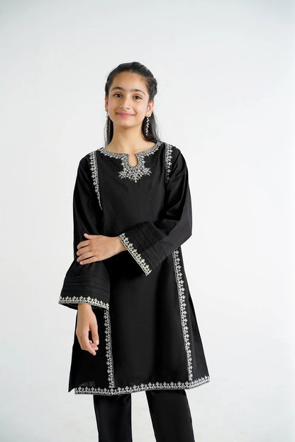 Lily black cotton kurta with white embroidery on neckline and sleeves, paired with black pants.