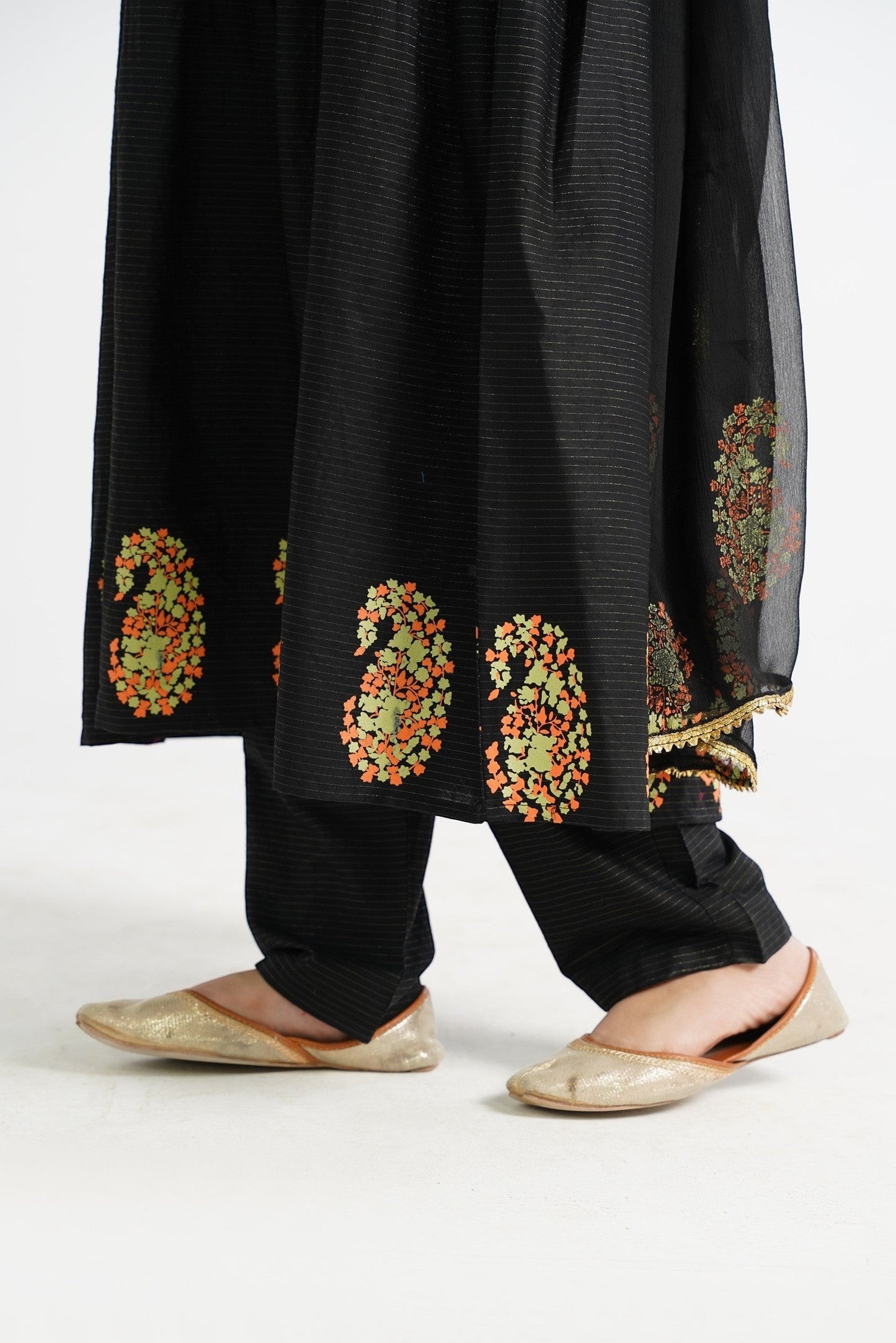 Lily black embroidered paisley print kurta set with matching trousers and gold flats. Traditional ethnic wear for festive occasions.