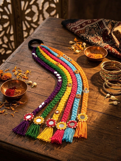 Lily bohemian braided hair accessory with rainbow yarn, mirrors, and tassels. Attaches to ponytail or bun.