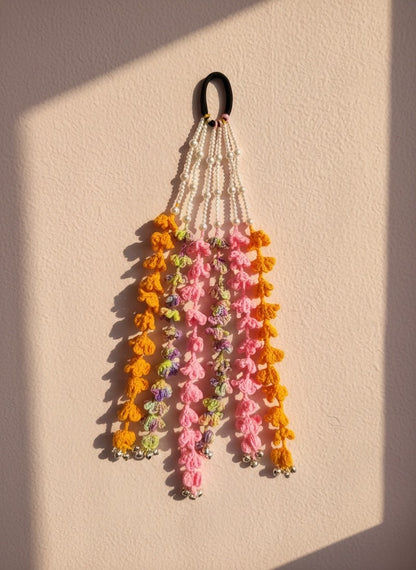 Lily bohemian hair accessory with crochet tassels in orange, pink, purple, white beads, and silver bells.
