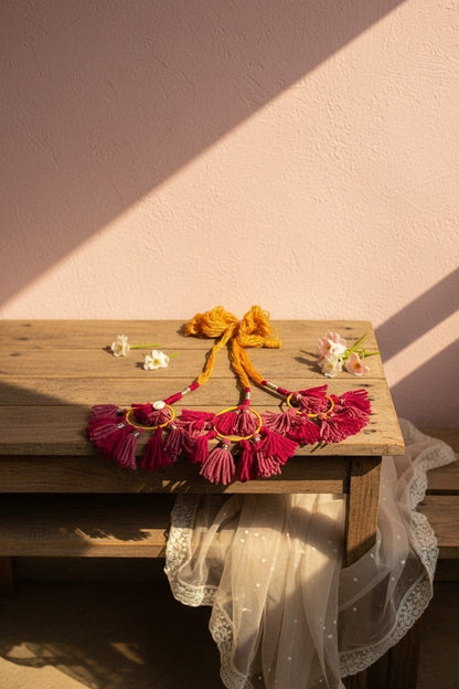 Lily bohemian tassel hair accessory with magenta, mustard yellow threads, shell accents, and yellow bow. Handcrafted for braids or handbags.