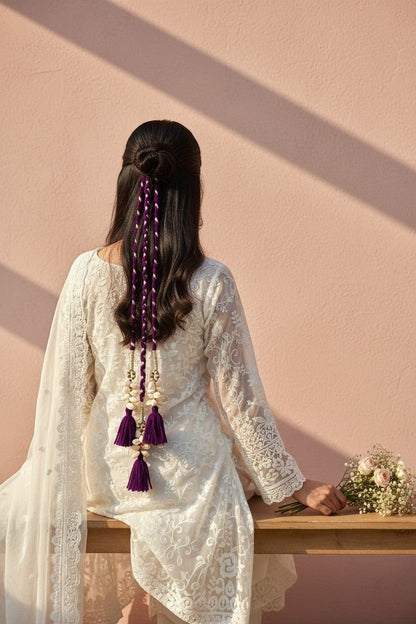 Lily braided hair accessory with purple & white cord, shells, beads, and tassels. Bohemian style.