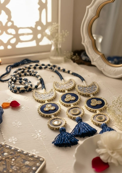 Lily Chaand Rani Paranda featuring navy blue and cream embroidery, mirror work, and elegant tassels for ethnic hair.
