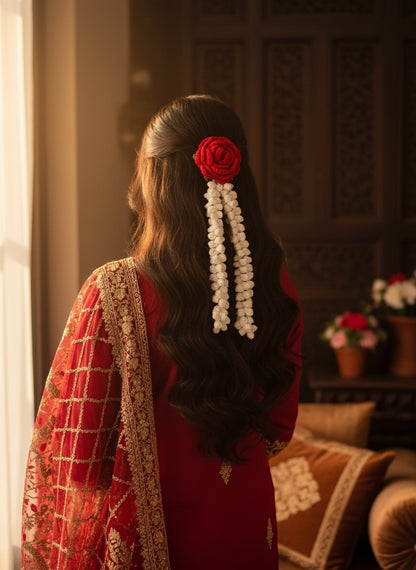 Lily handmade crochet red rose and cream jasmine hair accessory worn by a woman in a red ethnic outfit
