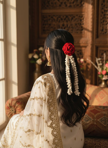 Lily handmade crochet hair accessory with a red rose and cream jasmine strands worn by a woman in a white outfit.