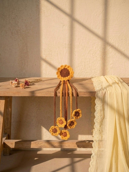 Lily handcrafted crochet hair accessory with sunflower motif and dangling floral accents in yellow and brown.
