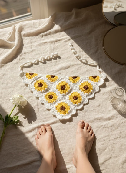 Lily handmade crochet sunflower headscarf in yellow and white, featuring a triangular bandana design on linen fabric.