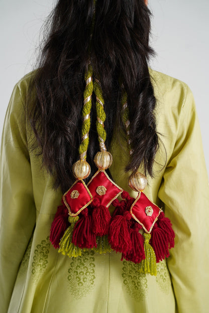 Lily decorative tassels with braided gold and green cord, maroon fringe, and red satin square accents with gold embroidery.