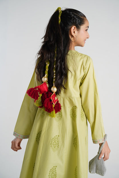 Lily Dil Ruba decorative tassels with maroon fringe, red satin square, and gold embroidery, attached to a girl's braided hair.