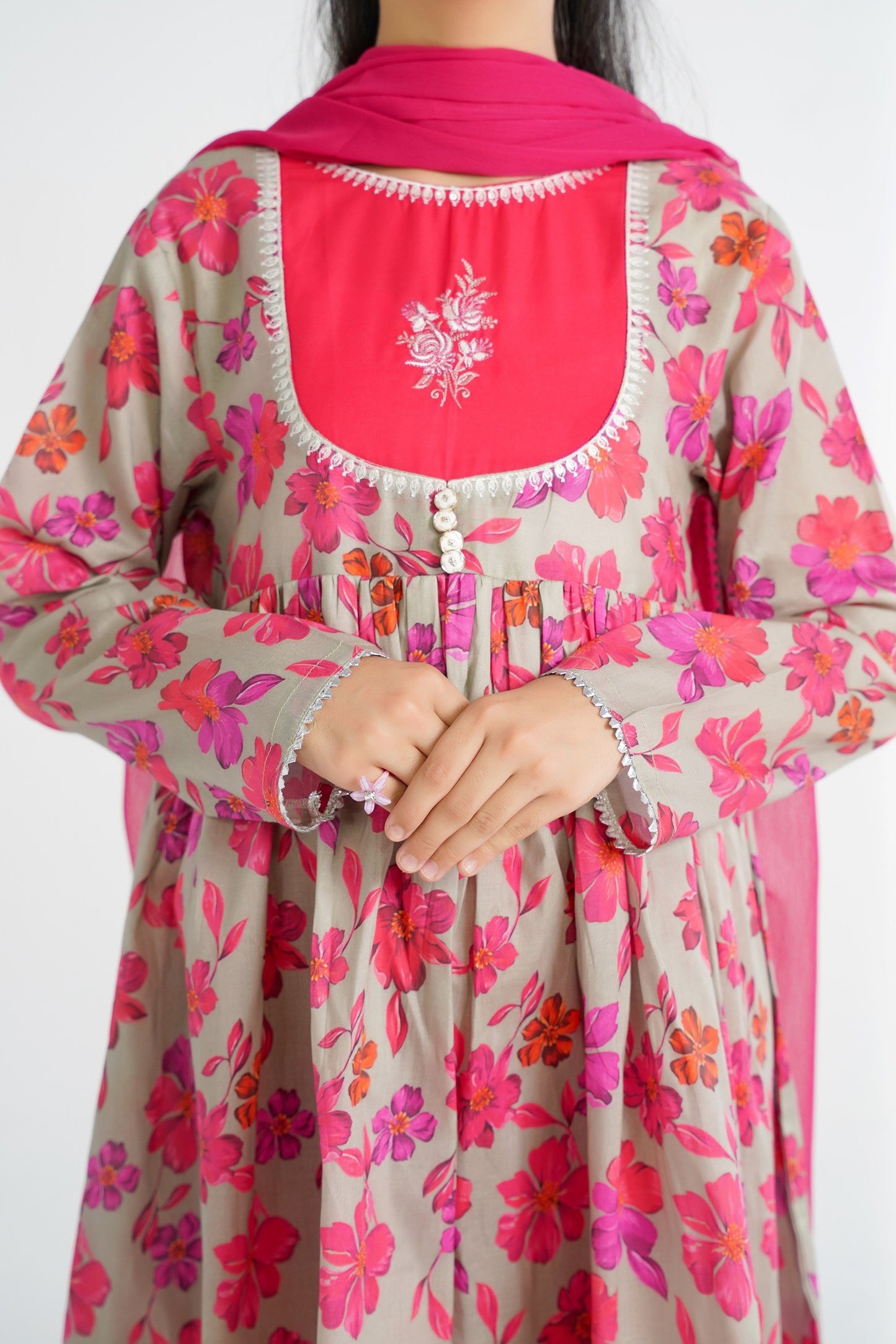 Lily grey cotton kurta with pink floral print, hot pink yoke with embroidery, and silver trim. Paired with matching pants and dupatta.