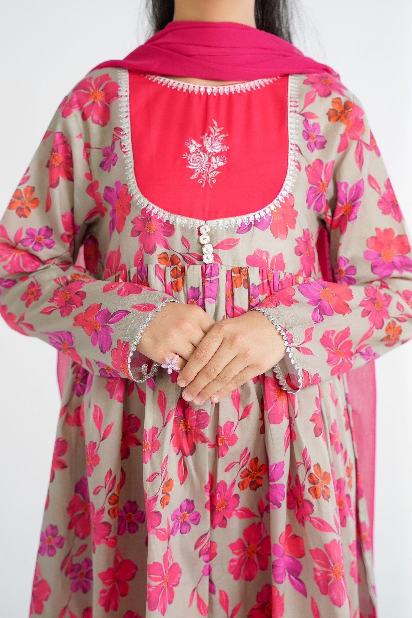 Lily grey cotton kurta with pink floral print, hot pink yoke with embroidery, and silver trim. Paired with matching pants and dupatta.