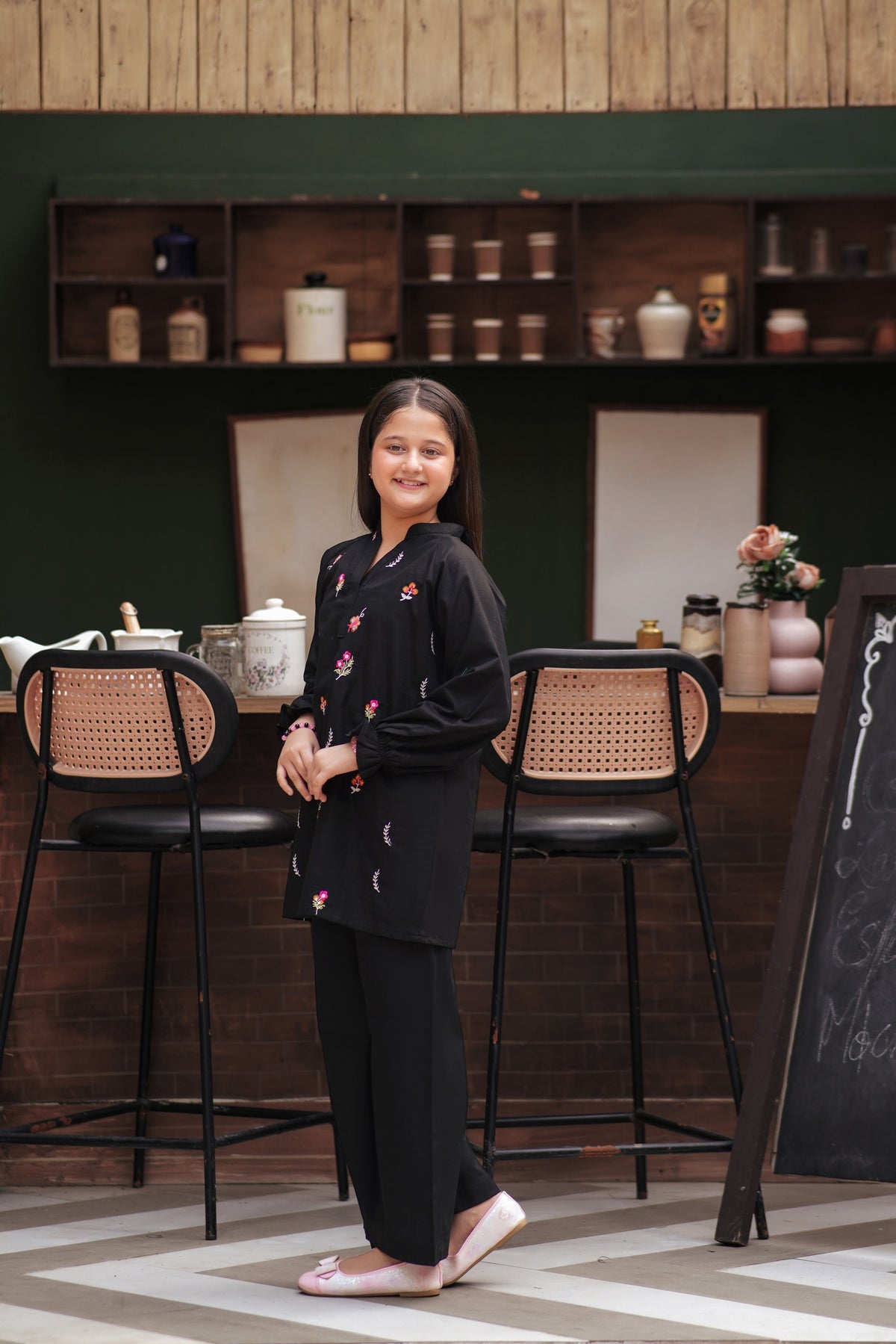 Lily girls black tunic and trouser set with multi-colored floral embroidery, long sleeves, and ruffled cuffs
