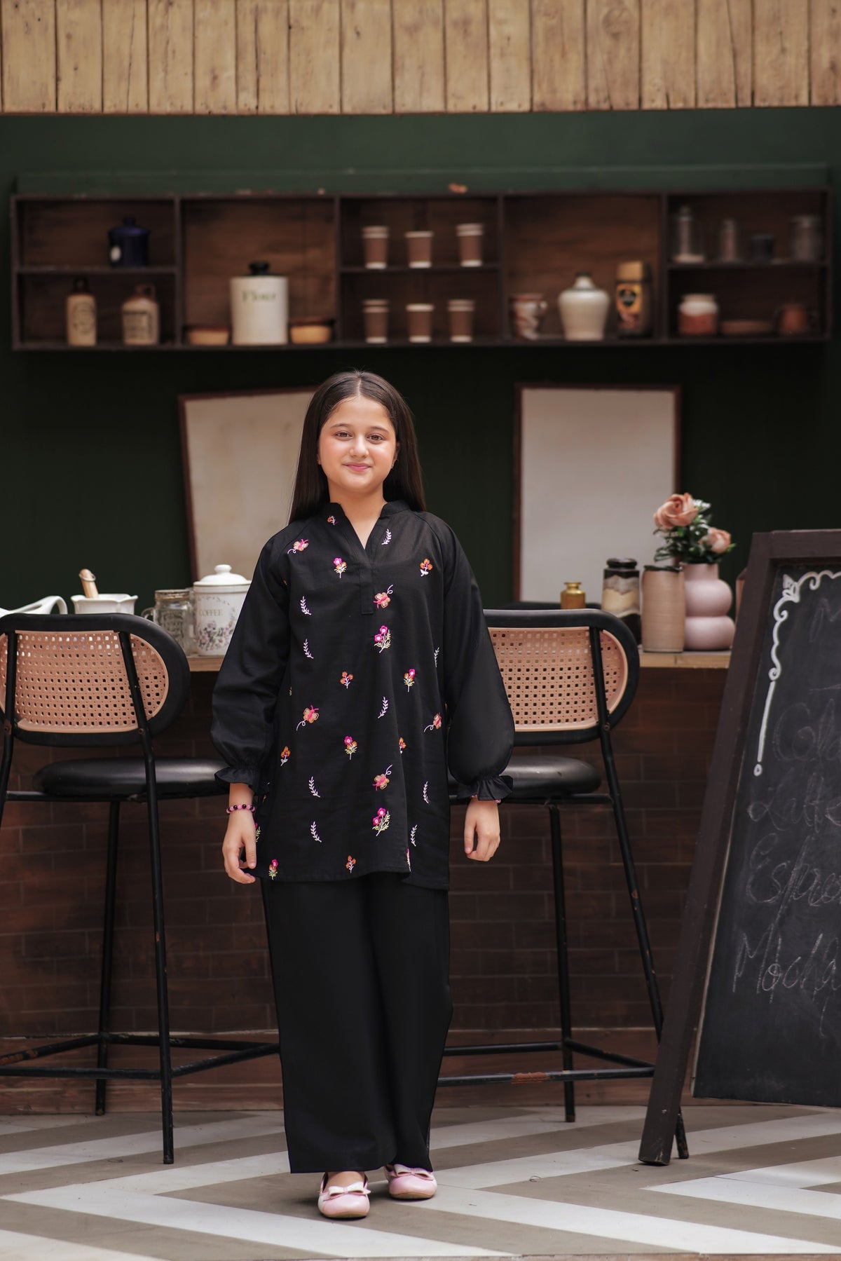 Lily girls black tunic and trouser set with colorful floral embroidery, long sleeves, and ruffled cuffs