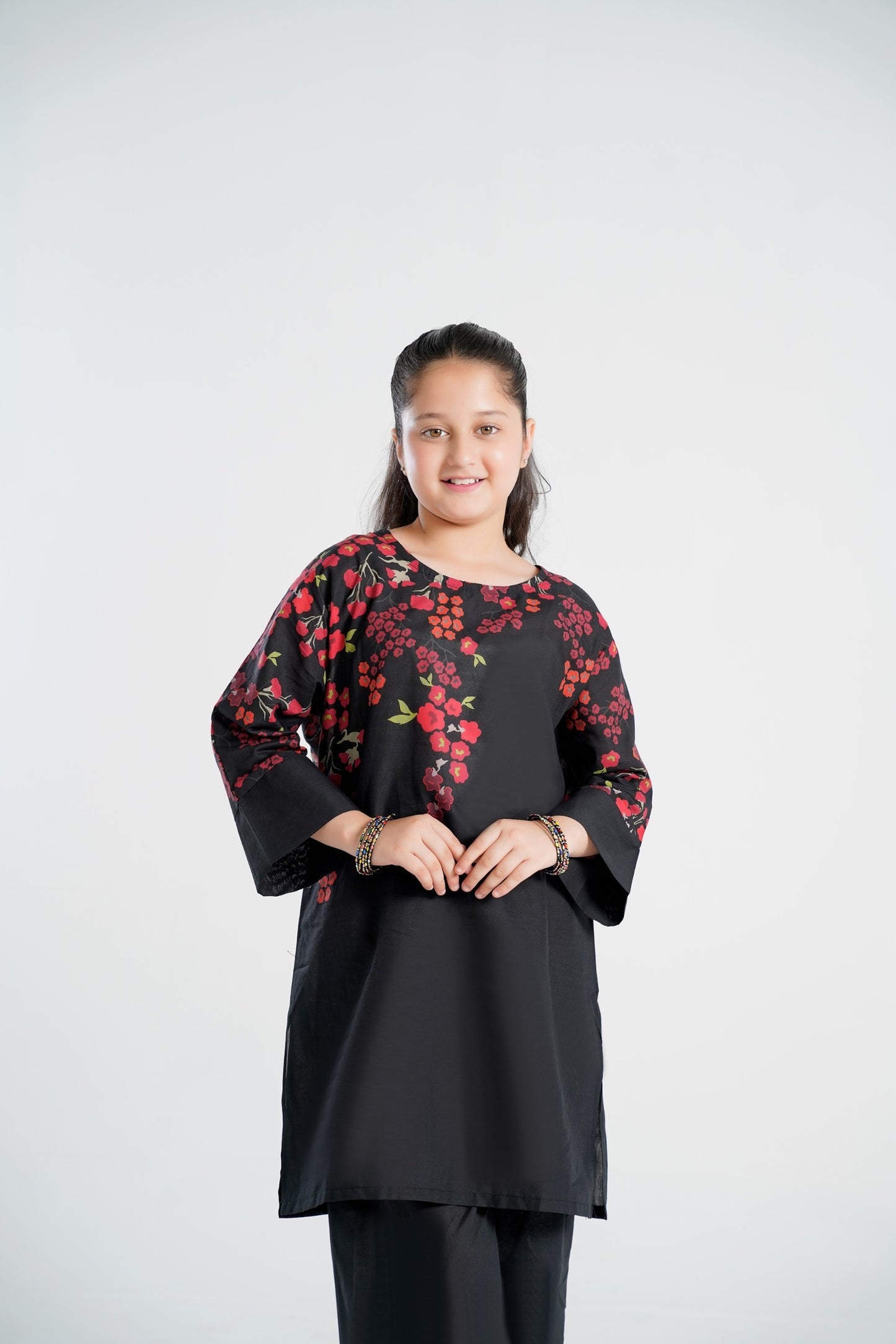 Lily black girls kurti with red and orange floral print on sleeves and neckline, flared sleeves, paired with black pants.