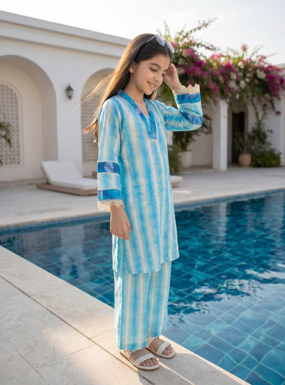 Lily girls blue and white tie-dye kurta set with lace trim and wide-leg trousers, worn by a girl by a swimming pool.