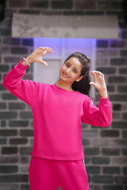 Lily girls hot pink crew-neck sweatshirt and matching trousers with white side-stripe detail on a smiling young girl