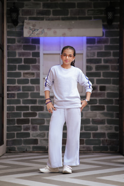 Lily girls white two-piece tracksuit with purple side stripes, featuring a relaxed fit top and matching trousers.