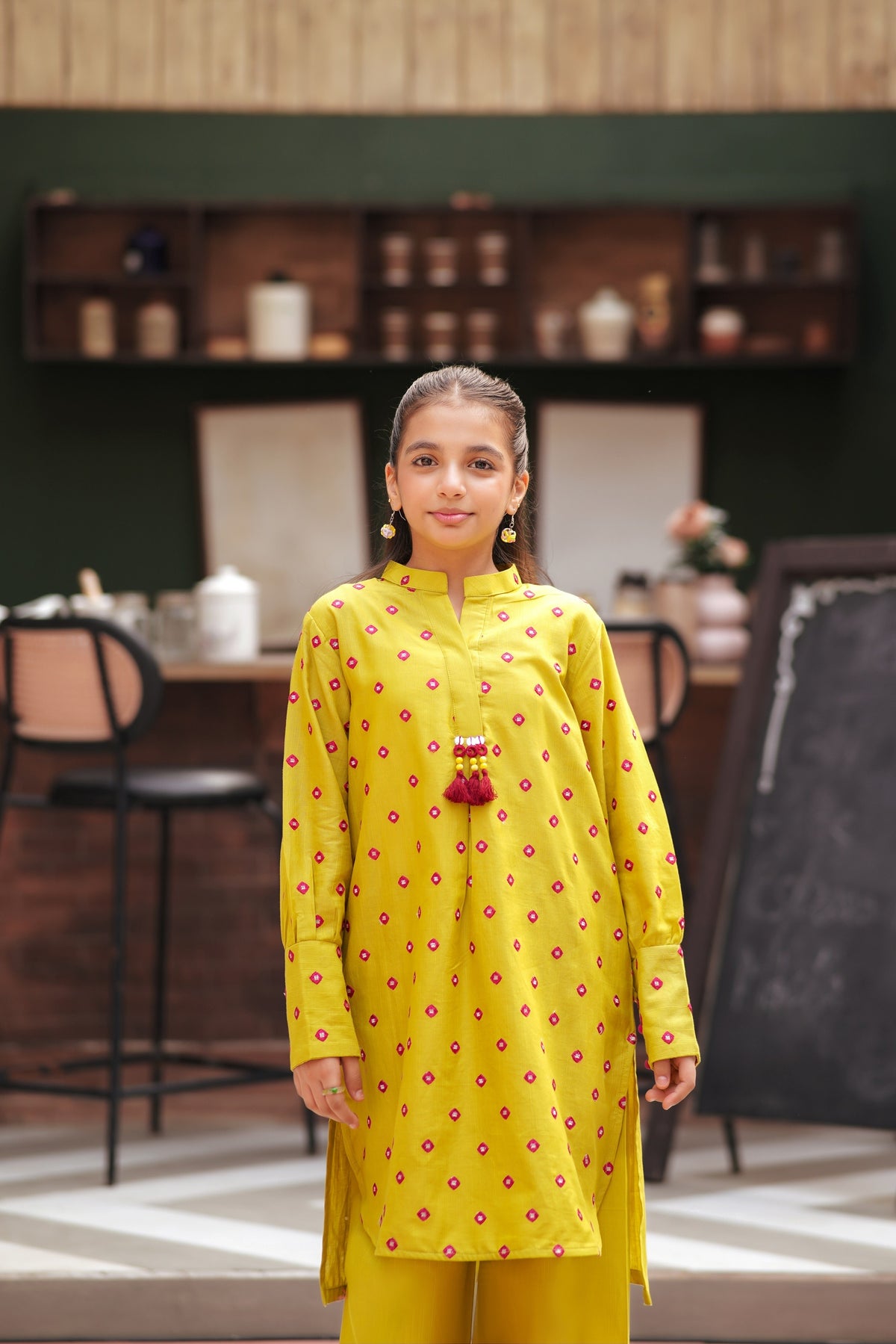 Lily girls yellow kurta and trouser set with pink geometric embroidery, mandarin collar, and tassel detail.