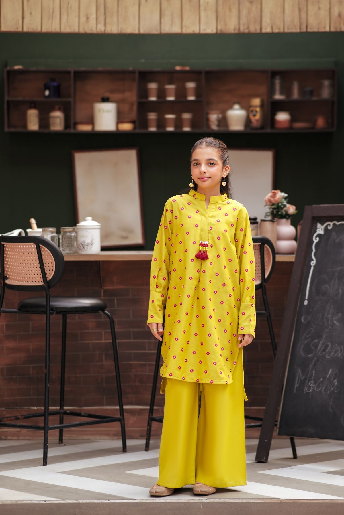 Lily girls yellow kurta and trouser set with pink geometric embroidery, mandarin collar, and tassel detail.