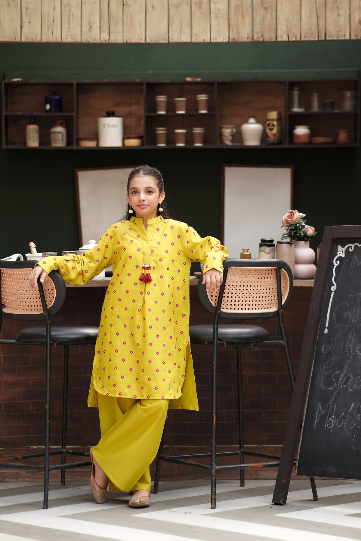 Lily girls yellow kurta and trouser set with pink geometric embroidery, mandarin collar, and tassel detail.