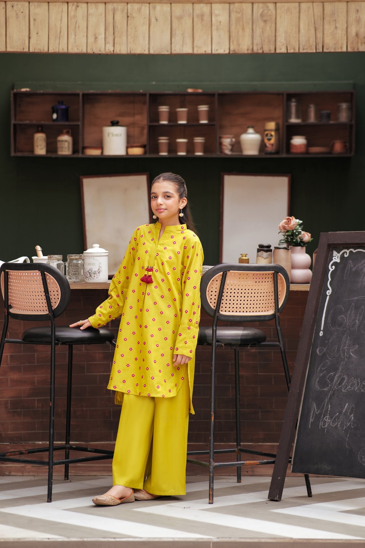 Lily girls yellow kurta and trouser set with pink geometric embroidery, mandarin collar, and tassel detail.