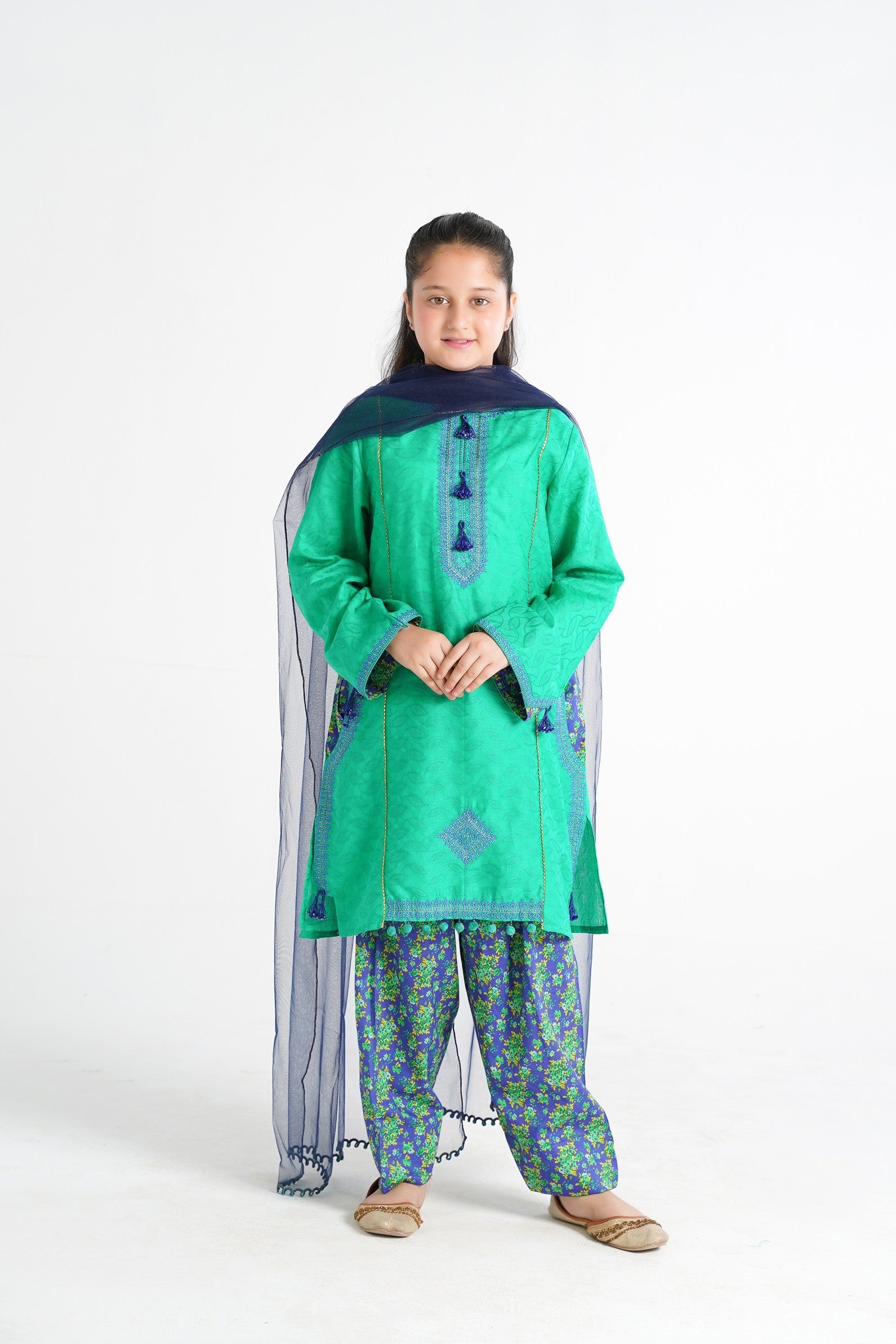 Lily green textured kurta with blue embroidery, tassels, printed pants, and navy dupatta on a girl.