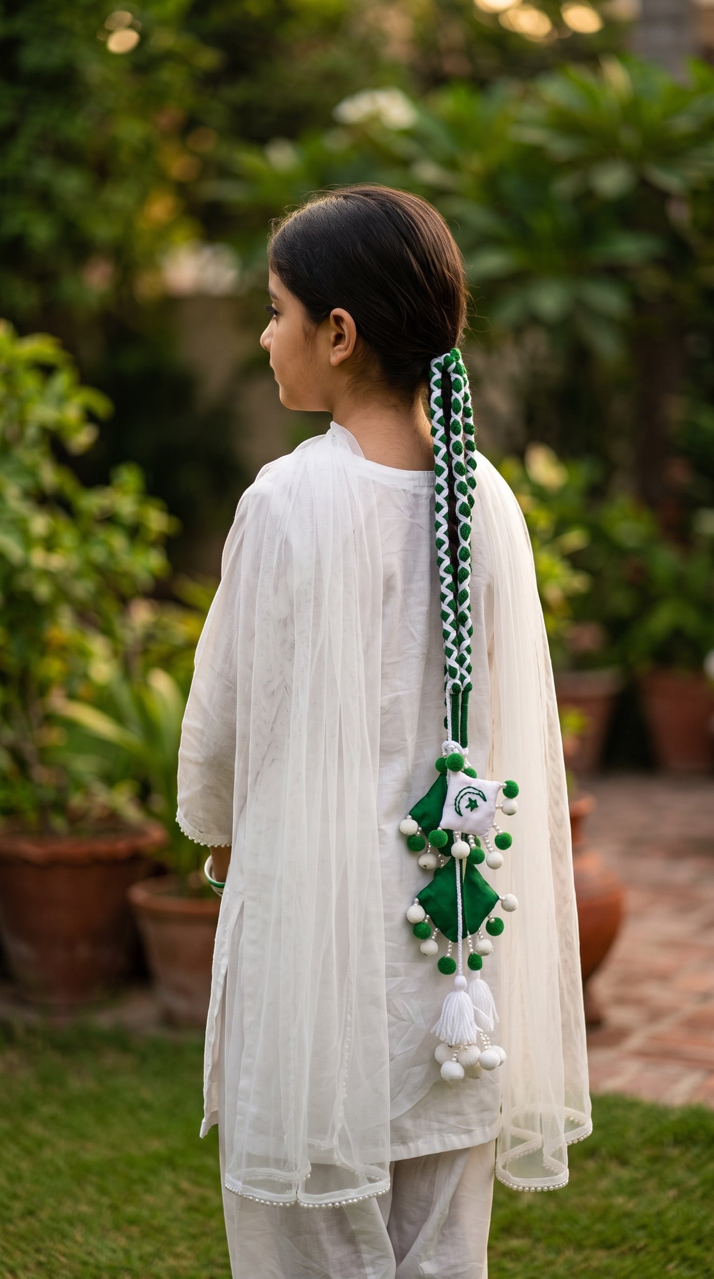 Lily 14 August special green and white braided paranda hair accessory with pom-poms and national emblem on a girl