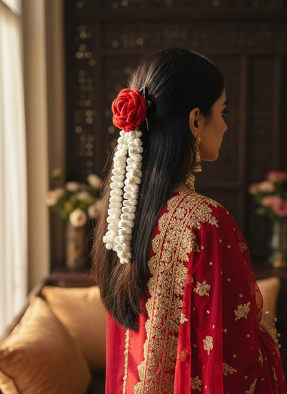 Lily handmade crochet hair accessory with a red rose and cream jasmine strands worn by a woman in a red ethnic outfit