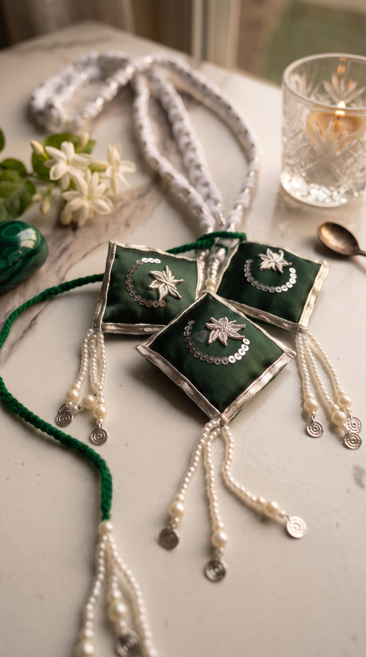 Lily Jashan-e-Azadi hair paranda in emerald green and white with embroidered star and crescent motifs and pearl beads.