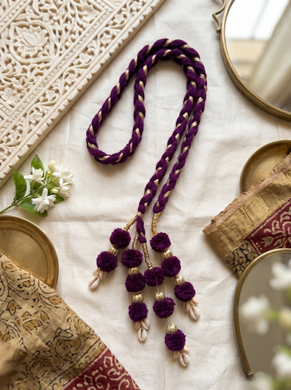 Lily Lavender Noor Paranda hair accessory featuring deep purple braided velvet with gold accents and cowrie shells.