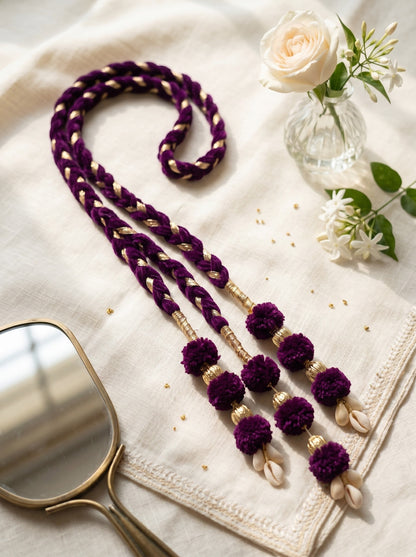 Lily Lavender Noor Paranda hair accessory in deep purple velvet with gold accents, pom-poms, and cowrie shell charms.