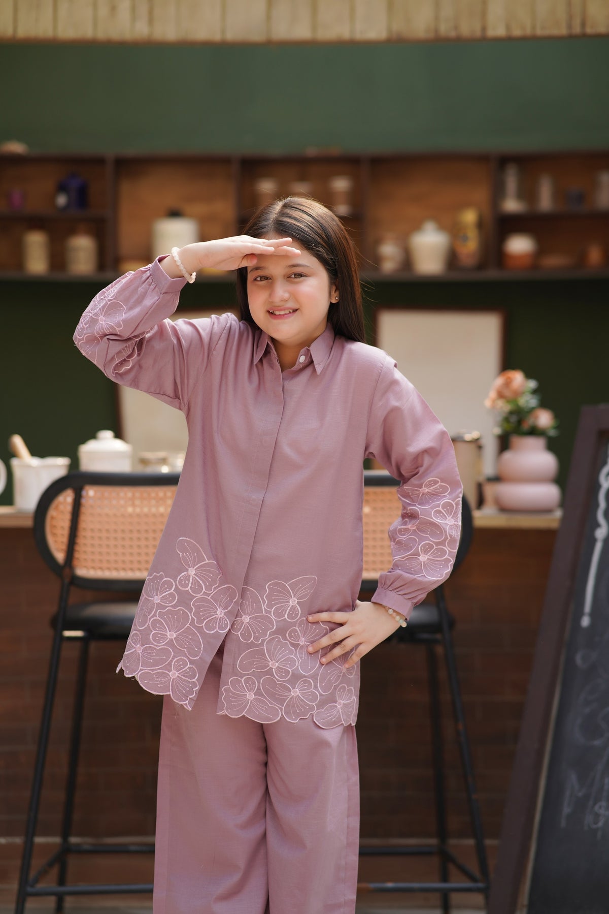 Lily girls mauve button-down shirt and trouser set with delicate floral embroidery in a cozy kitchen setting