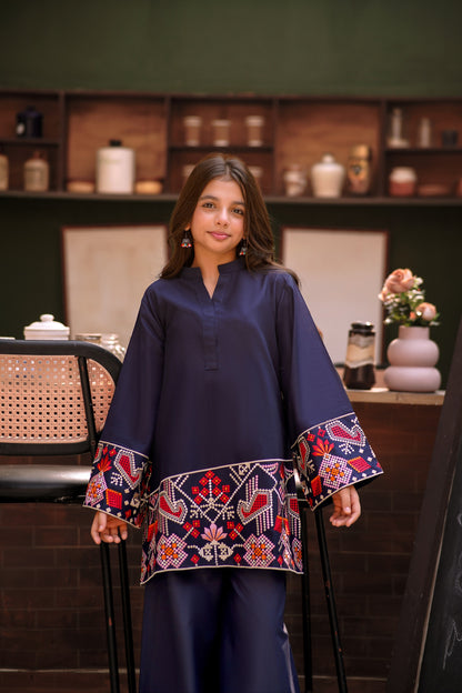 Lily navy blue two-piece kurta set with multi-colored geometric embroidery on the hem and wide sleeves on a young girl
