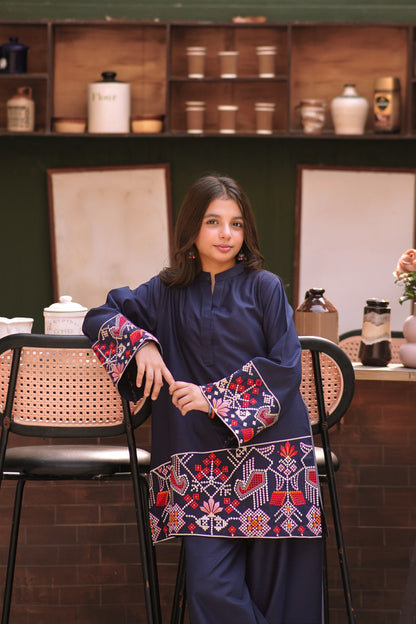 Lily navy blue two-piece kurta set with vibrant geometric embroidery on the wide sleeves and hemline worn by a girl