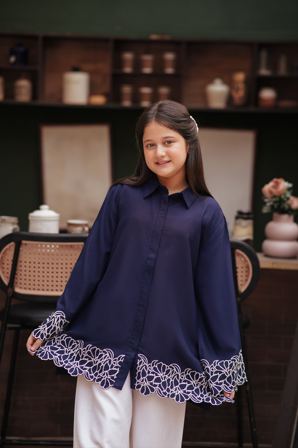 Lily navy blue long sleeve button-down tunic with white floral embroidery on the cuffs and scalloped hem