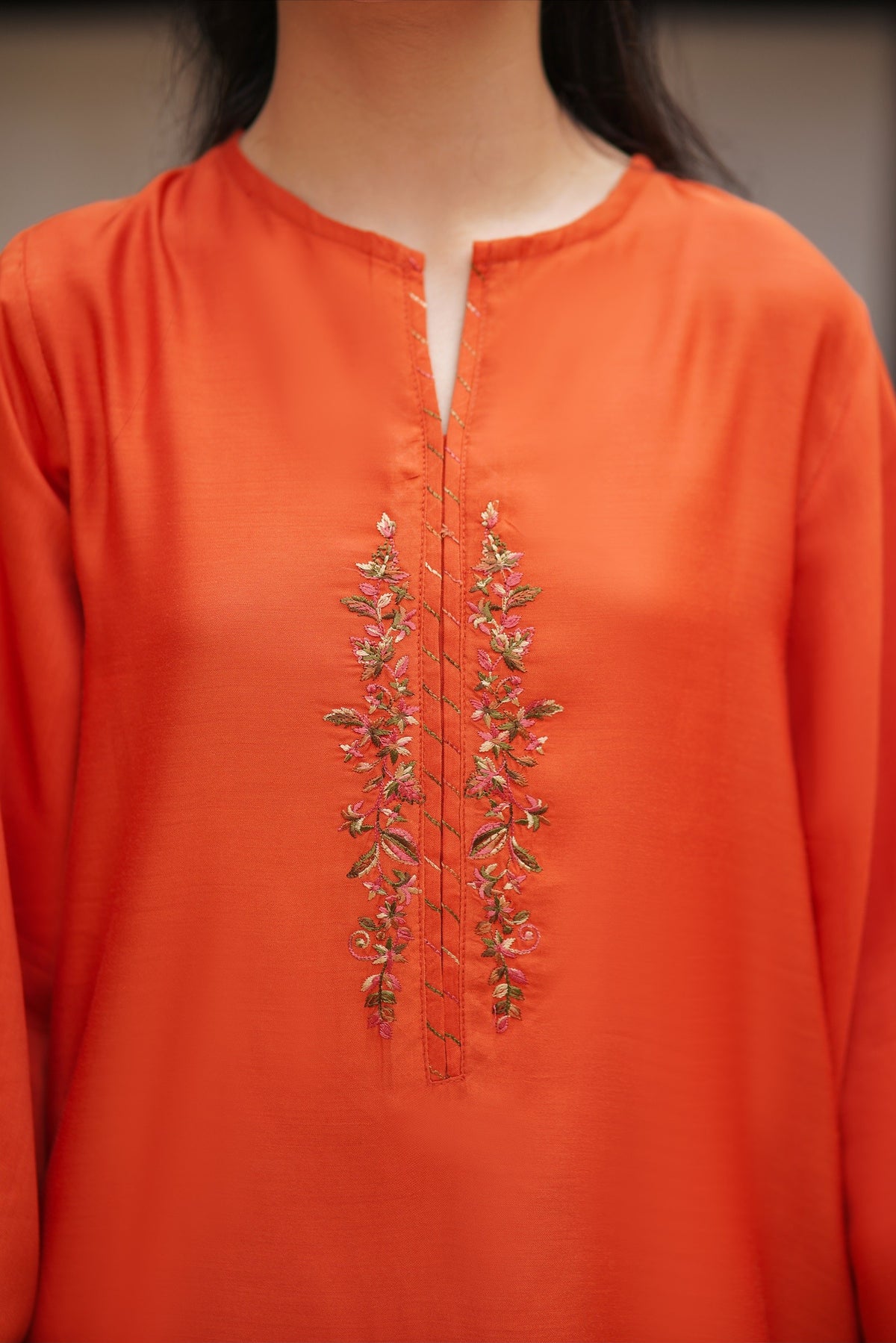 Lily orange kurta featuring delicate floral embroidery along the neckline and a minimalist silhouette