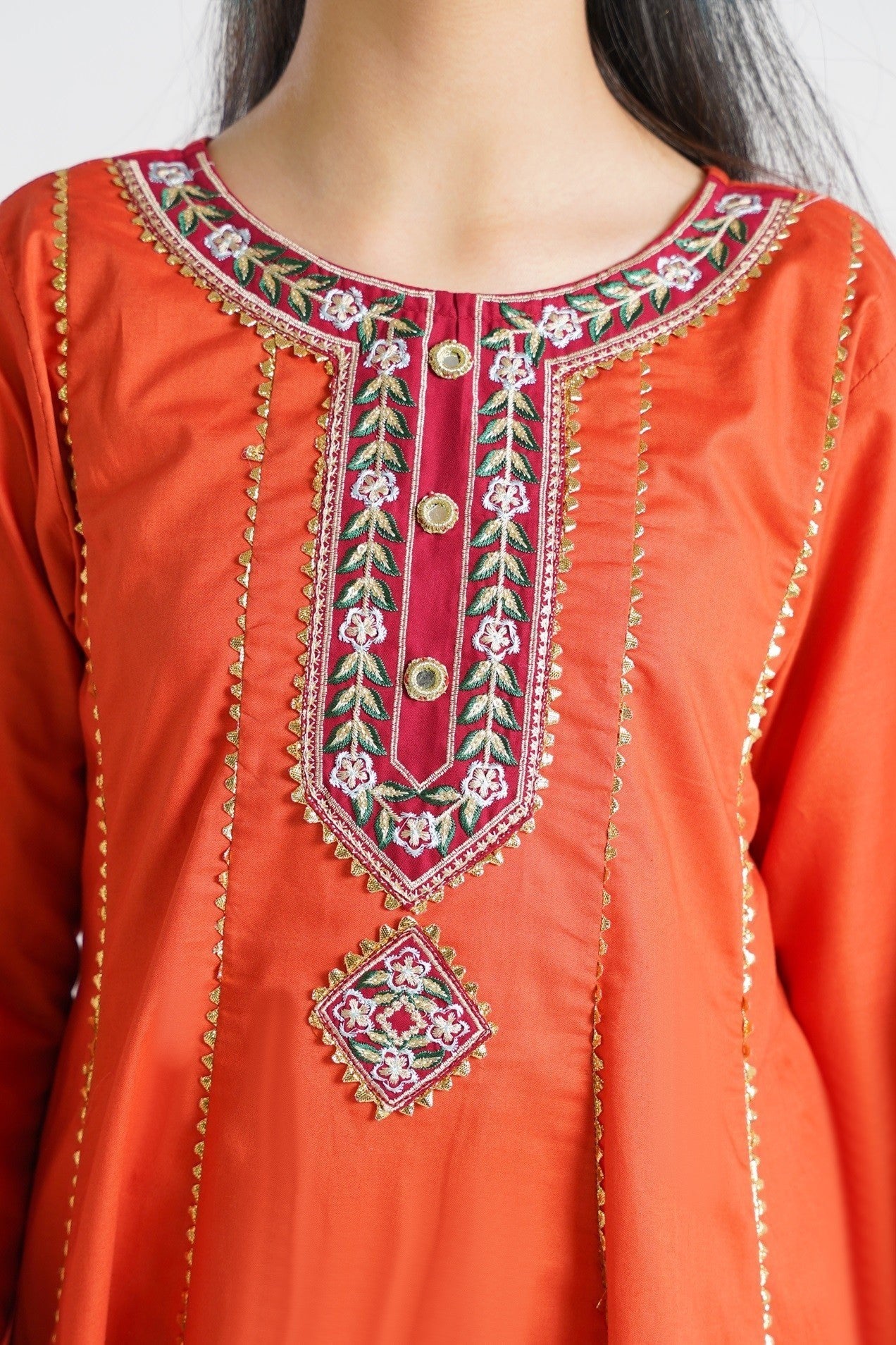 Lily orange embroidered kurta set for girls with maroon panels and gold print. Features flared kurta, matching pants, and dupatta.