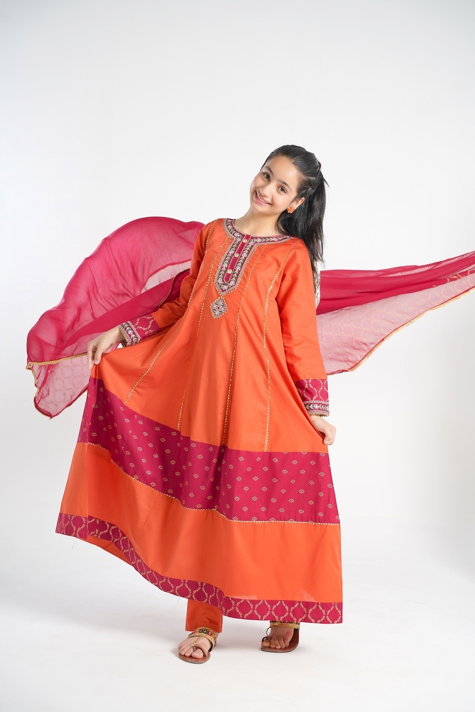 Lily orange embroidered kurta set with pants and dupatta for girls. Features gold print and maroon panels.