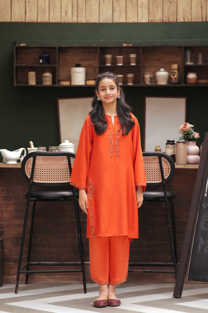 Lily orange kurta and trouser set with delicate floral embroidery on the neckline and sleeves worn by a young girl