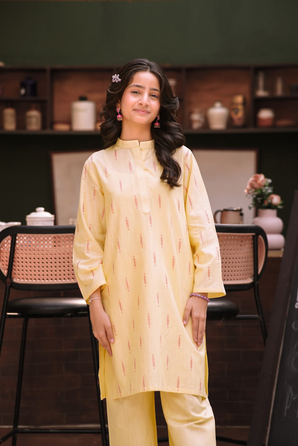 Lily pastel yellow two-piece kurta set with vertical patterns, mandarin collar, and wide-leg trousers on a young girl