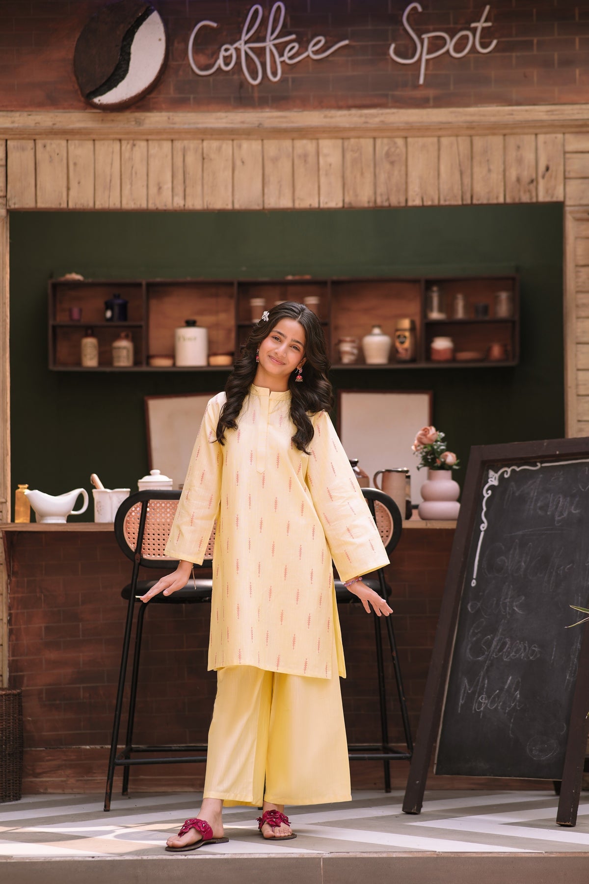 Lily pastel yellow two-piece kurta set with vertical patterns, mandarin collar, and wide-leg trousers on a young girl.