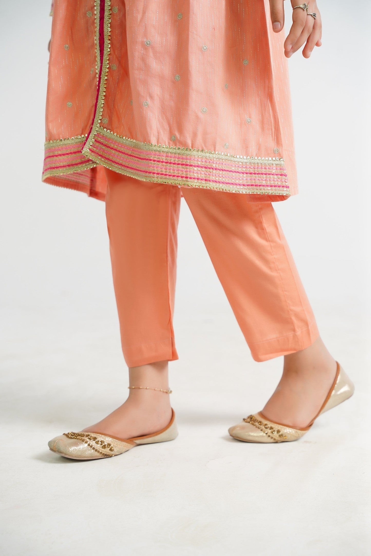 Lily peach embroidered kurta and pants set with floral motifs and border detailing. Lightweight fabric.