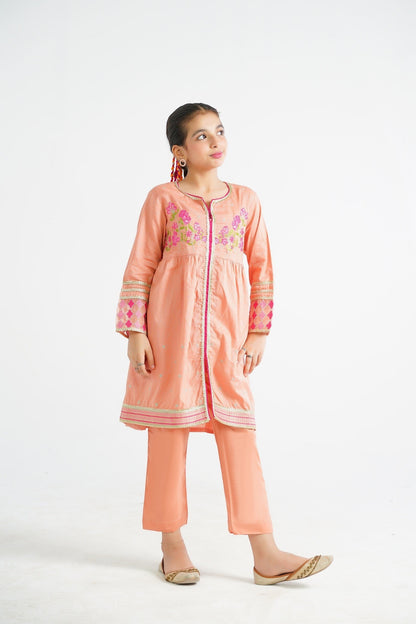 Lily peach embroidered kurta and pants set with floral motifs and border detailing. A young girl models the outfit.