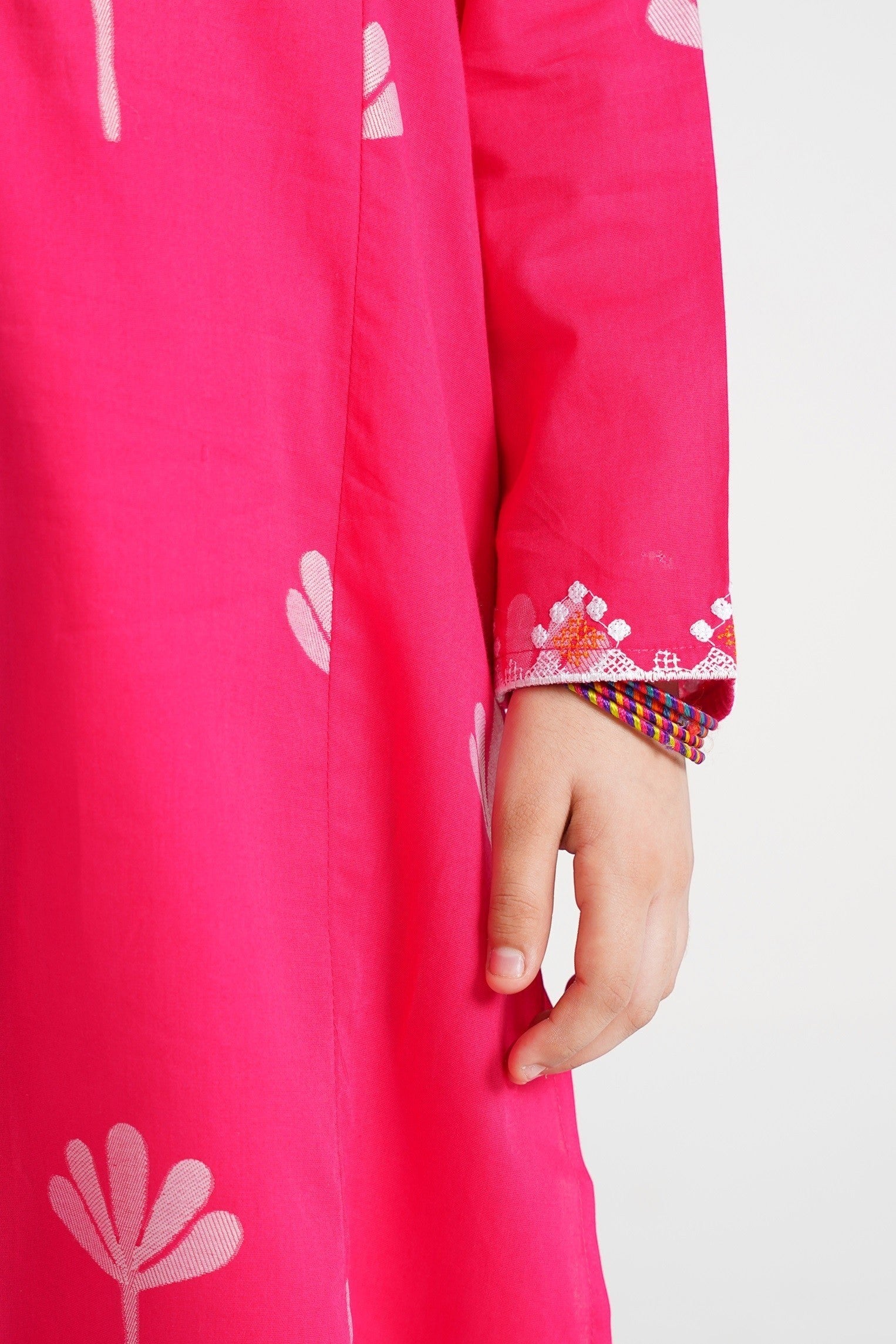 Lily pink cotton kurta with floral print and embroidered cuffs, worn by a child.